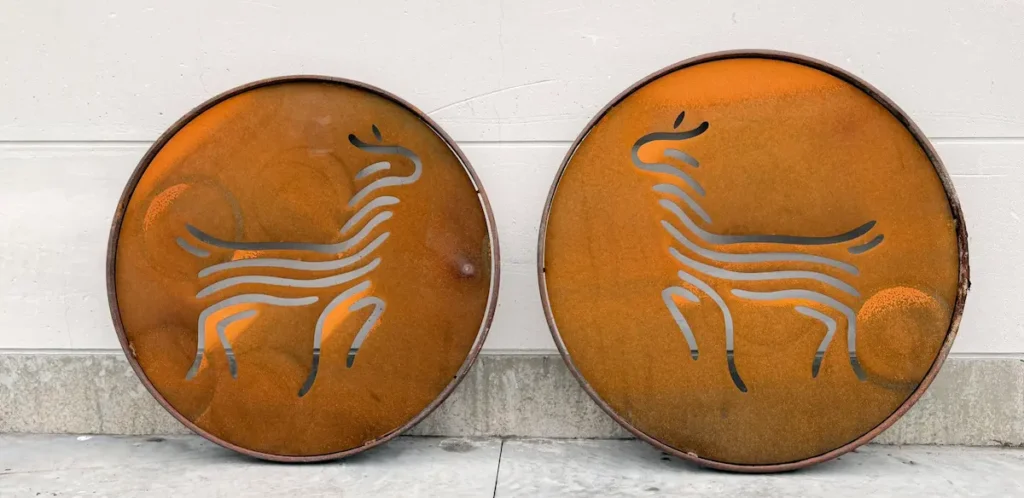 Twee oude karrewielen met ingewerkte cirkels en alpaka‑figuren, volledig op maat gemaakt